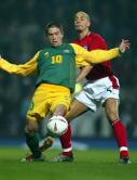 Harry Kewell shields the ball from Rio Ferdinand